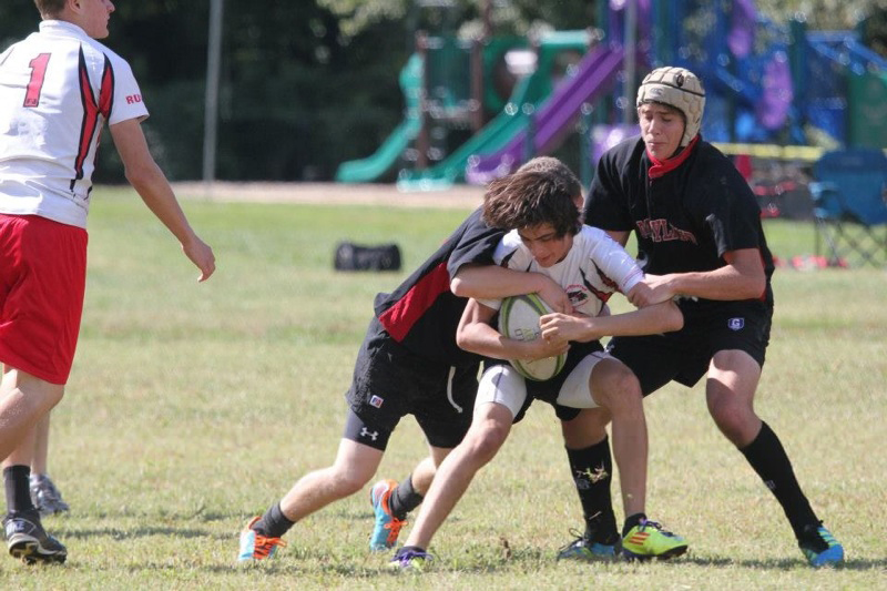 Junior+Anthony+Wright+is+tackled+by+rivals+during+a+rugby+match.