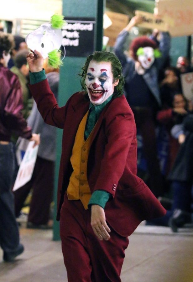 The+joker+in+the+street+during+one+of+the+scenes+in+the+movie.