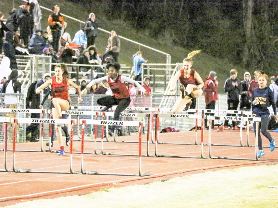 Alyssa (left) and Stephanie (right) compete against each other in the hurdle race.
