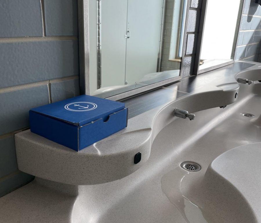 The blue boxes can be found in public places within the school such as in the multi-stall bathrooms sitting on the edge of the sinks.