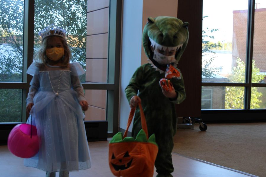 Childhood Development students take preschoolers trick-or-treating to different classes.