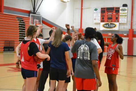 The varsity girls huddle up during practice to get hype before the next workout set.