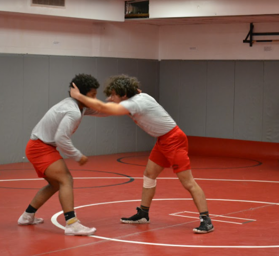 Two of the captains, Kingsley (left) and Bryce (right), wrestle one another at practice to prepare for their season events.