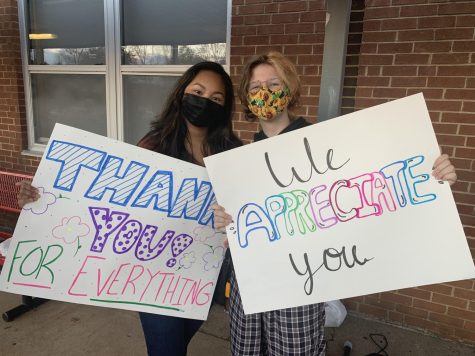 Senior Jenilyn and junior Finn participate in Wonderful Wednesday of Positivity with hand made thank you signs.