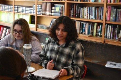 Poetry and pose club member reading their poem out loud.