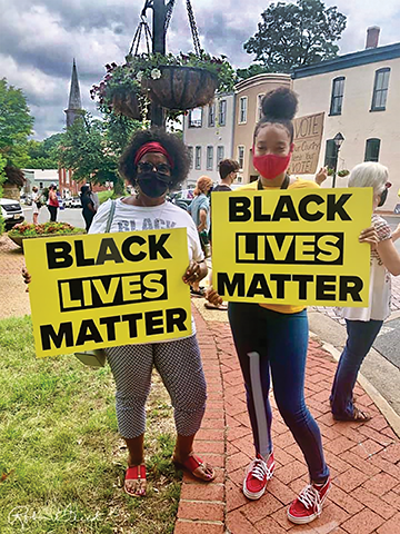 Two vigil attendees proudly display their signs.