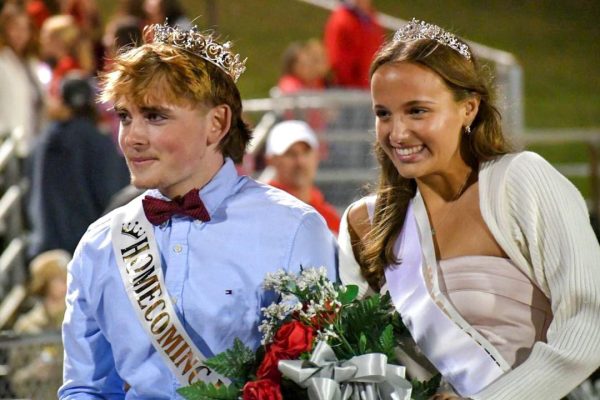 Meme Merchant and Brandon Frear take the joy ride after being crowned HOCO king and queen.