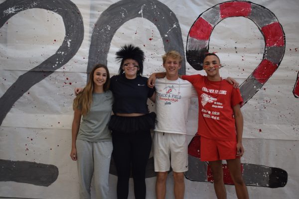 Freshman Brooke Maso, sophomore Kiersten Clark, junior Sam Pacassi, and senior Riley King dress up for class color Falcon Friday as the spirited students of FHS.