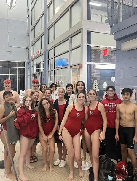 The swim team takes a fun picture after a meet.