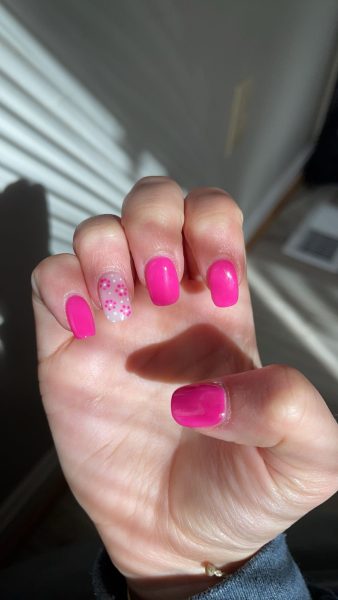 Junior Madelynne Martin shows off her nails, done at Envy Nails & Spa.