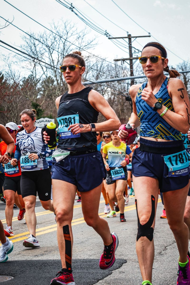 Librarian Rebecca Webster dashes past the camera while running the famous Boston Marathon.