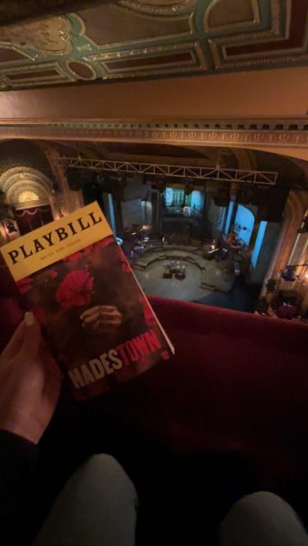 Student holding playbill of the musical Hadestown on a field trip to New York City.