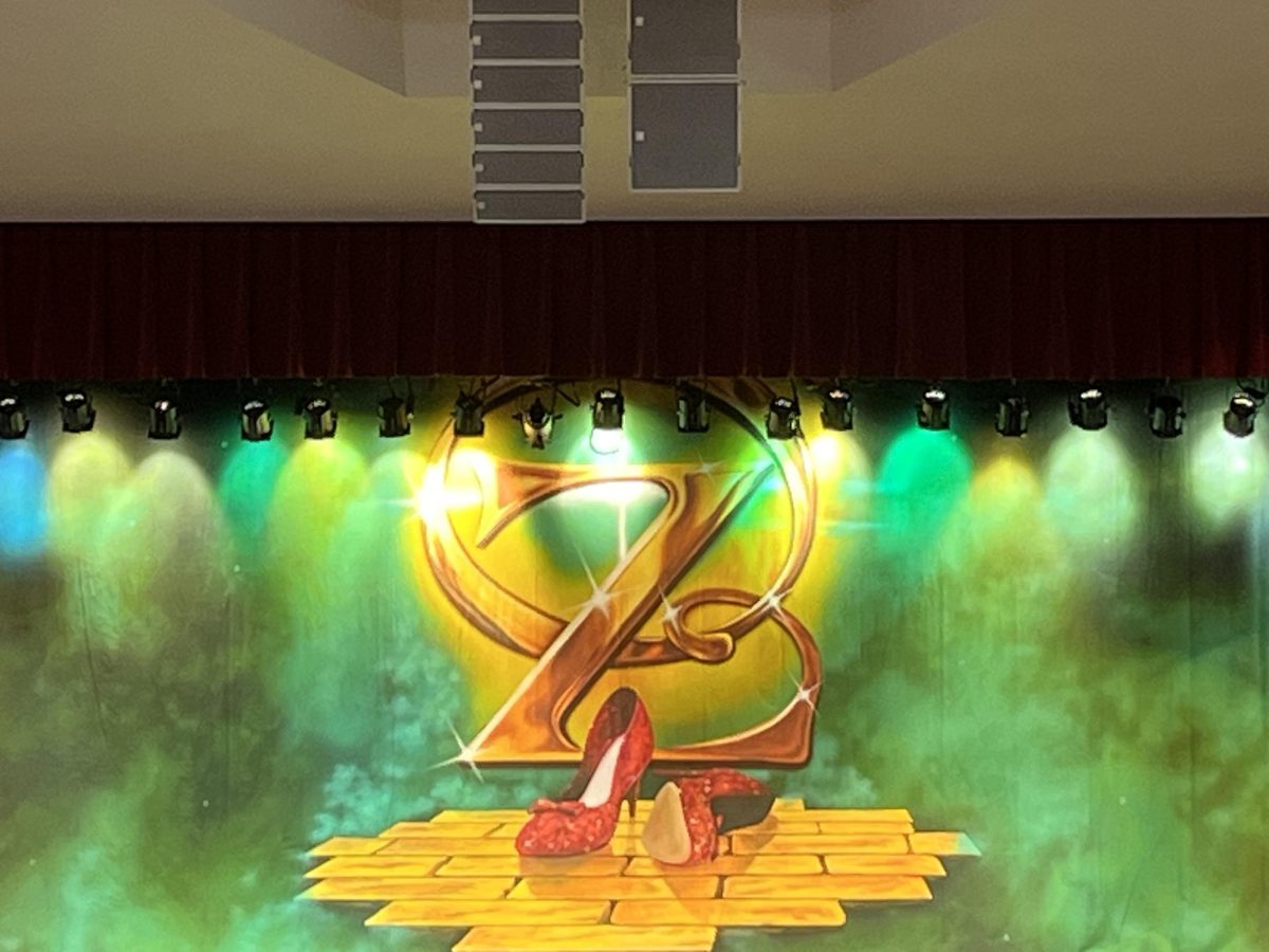 The beautiful auditorium stage at FHS displays the background image of The Wizard Of Oz.