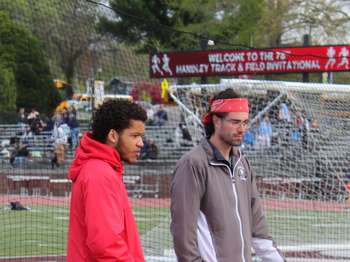 Sam Oravec, a new addition to Fauquier High School walks alongside a FHS student.