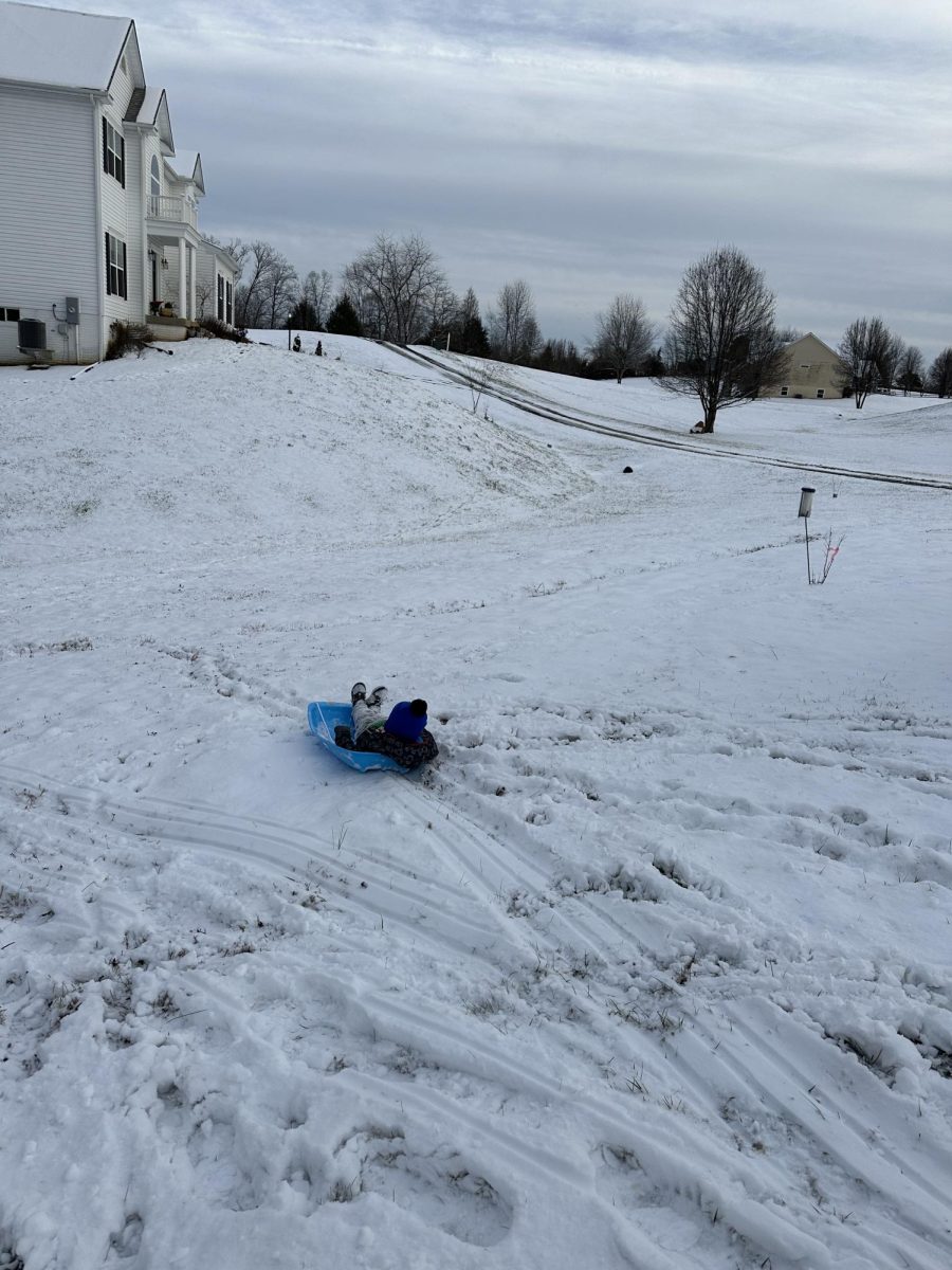 A child sledding during snowy Jan 2024. 