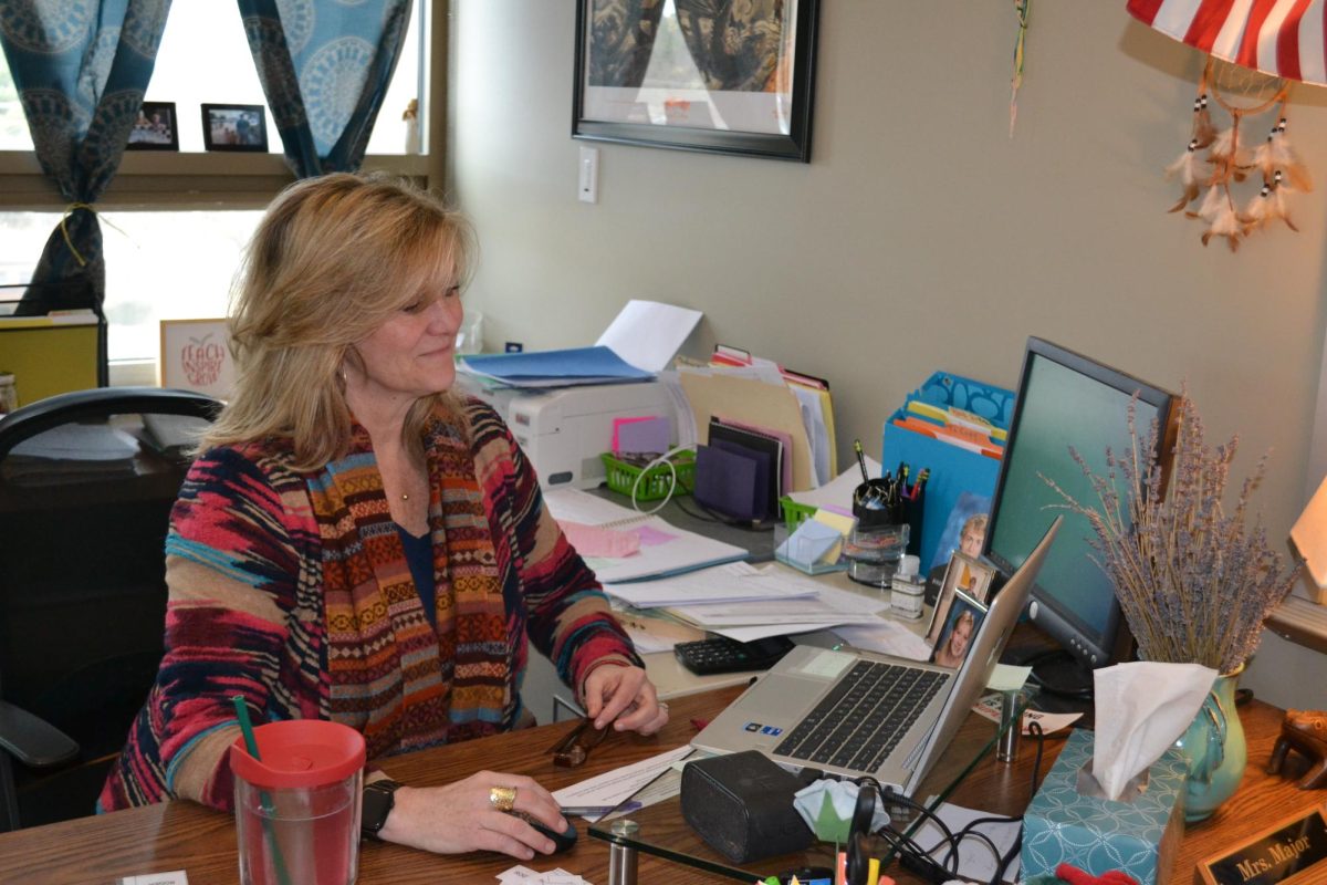 Jennifer Major working at her desk in her classroom.