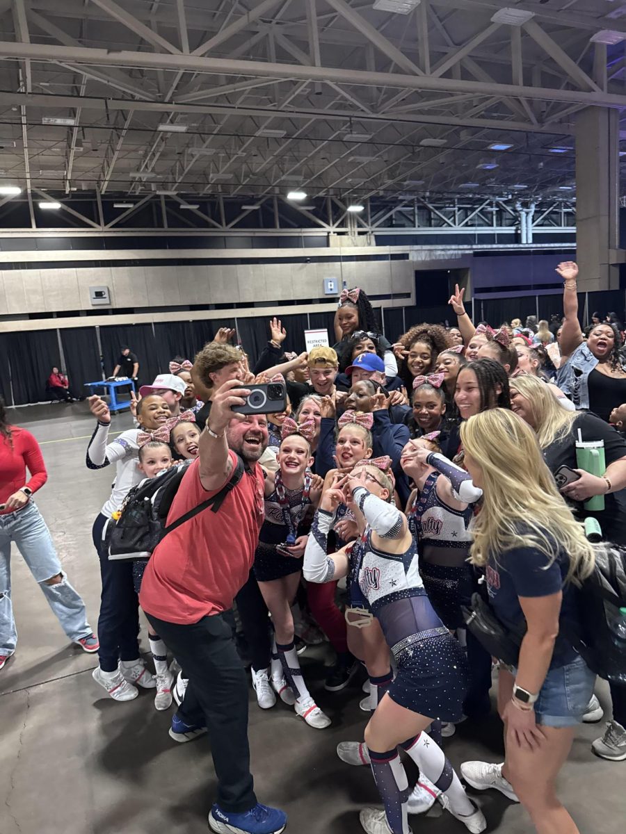 Virginia Royalty Cheer team taking a group picture after being given their awards at National Cheerleading Association Competition.