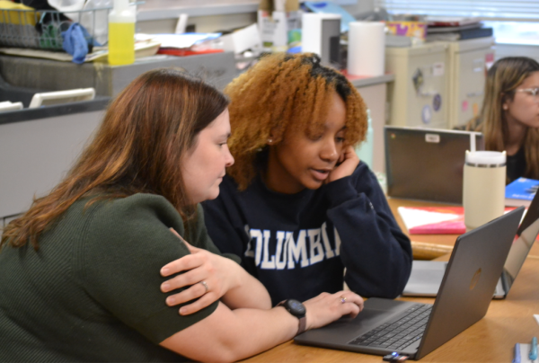 Sarah Ewing helps one of her students with photography edits.