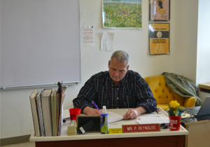 Paul Reynolds sits at his desk.