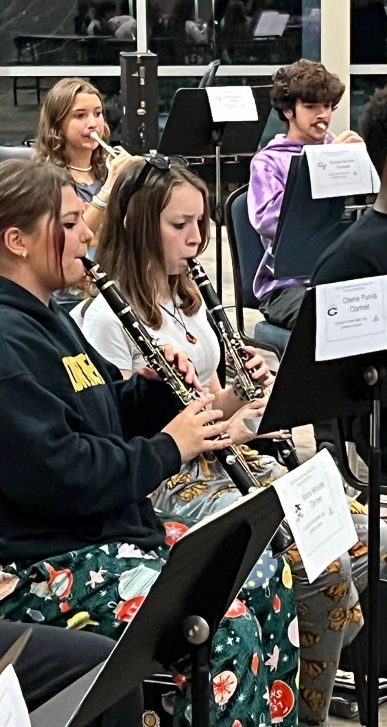 To the left sophomore, Hailey Purvis,  plays the clarinet.