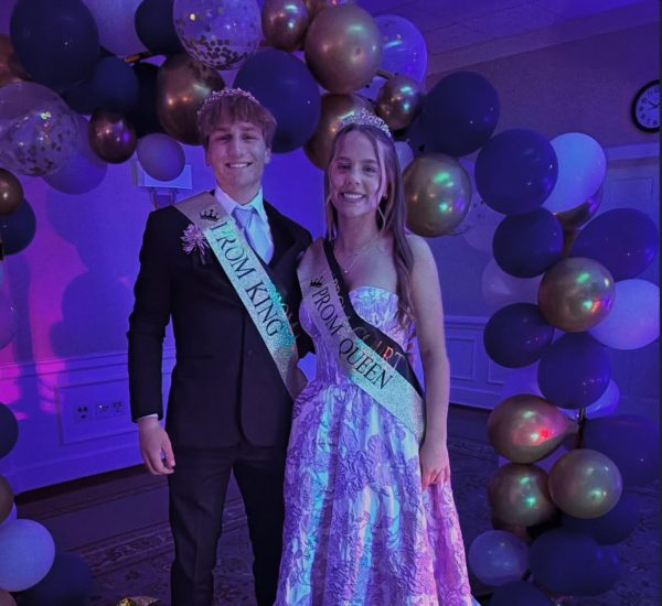 Prom King, Eli Rittenhouse, and Prom Queen, Madelynne Martin, smiling at their accomplishment.