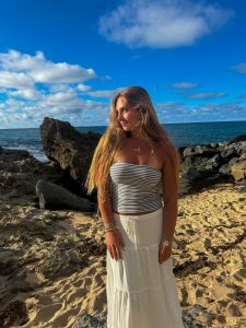 Nina Woodside flaunts her trendy, white linen skirt paired with her blue and white striped tube top.