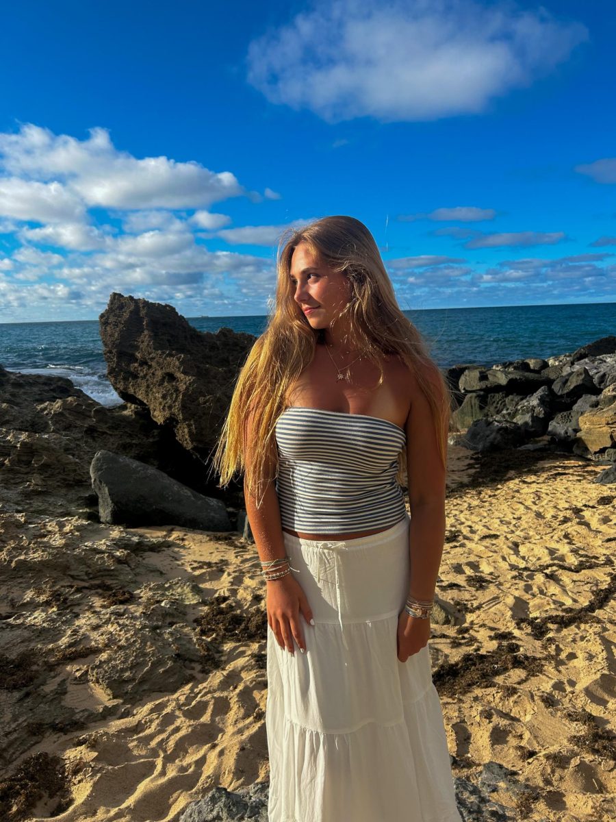 Nina Woodside flaunts her trendy, white linen skirt paired with her blue and white striped tube top.
