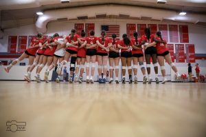 FHS volleyball team celebrates their accomplishments after a game. 