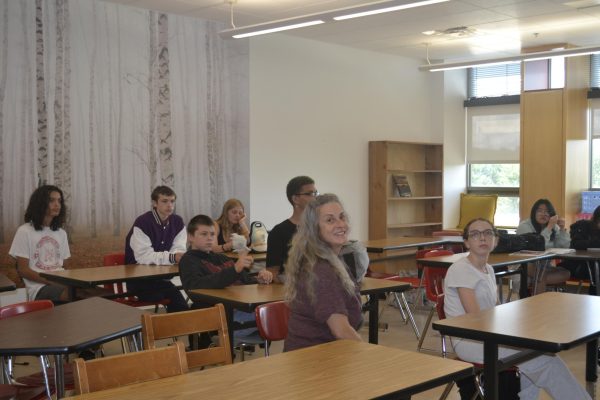 April Poland smiles with her joyful theatre students.