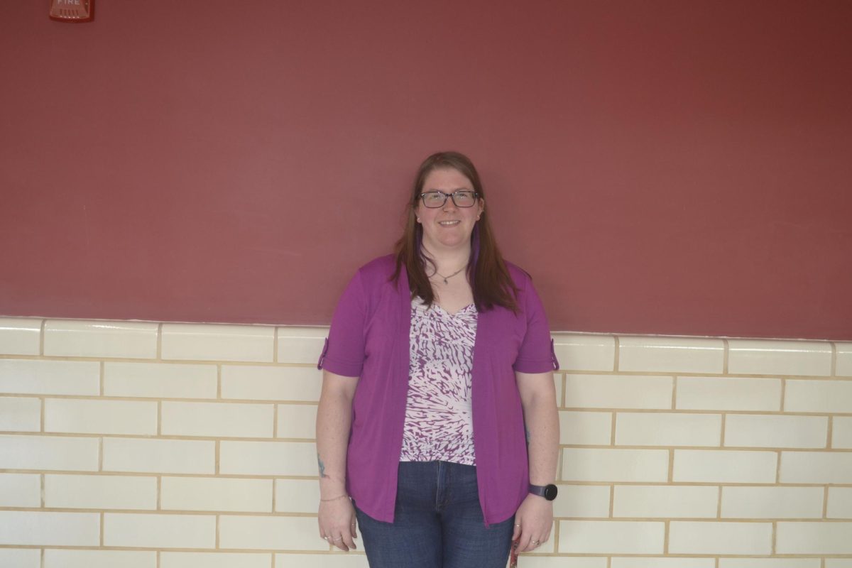 Dr. Sara Ansteatt stands proudly showing her excitment to join the science department at FHS.