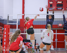 Triumphantly, Bailey Payton (number 1) hits the winning ball over the net.