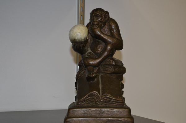 Eckenrode's statue depicting Darwin's Ape sitting pondering on his shelf.