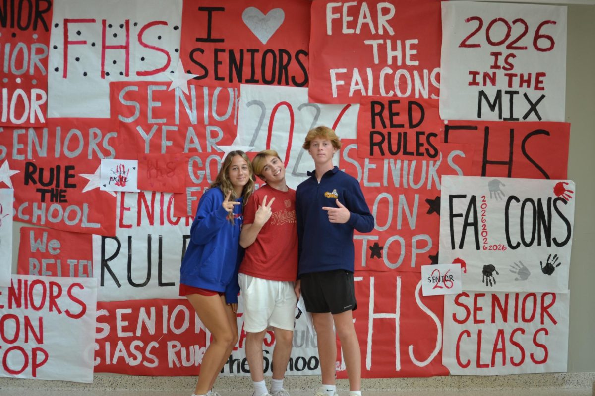 Left to right: Juniors Mailee Perez, Nathan Gibbs and freshmen Easton Blandford pose after decorating the hallways for FHS's spirit week.