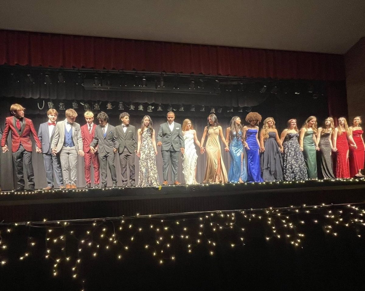 Models at the Fashion Show, organized by the Fashion Marketing class, stand on stage.