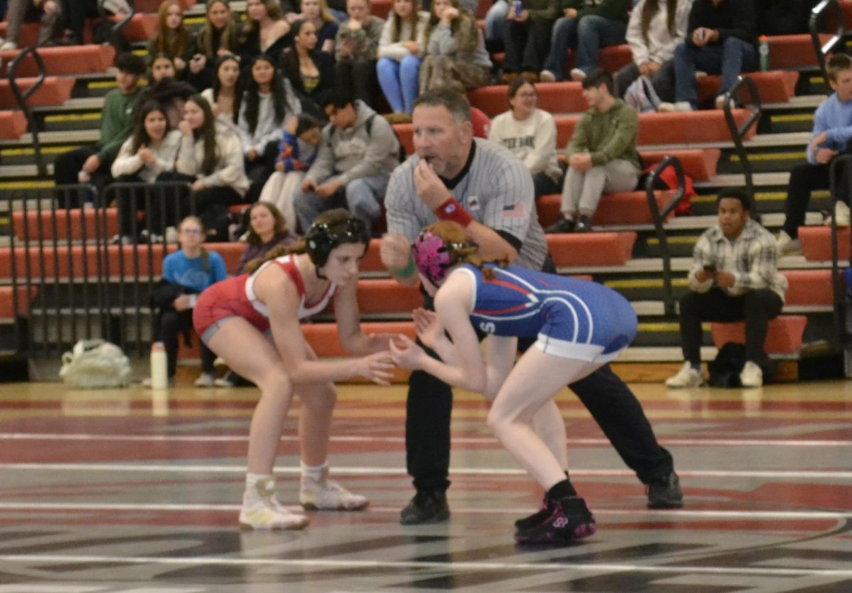 Fauquier High School Wrestler, Avery Sorrentino [left], gets ready to begin her wrestling match.