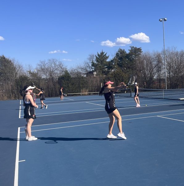 Tennis athletes prepare during tryouts for the new spring sports season.