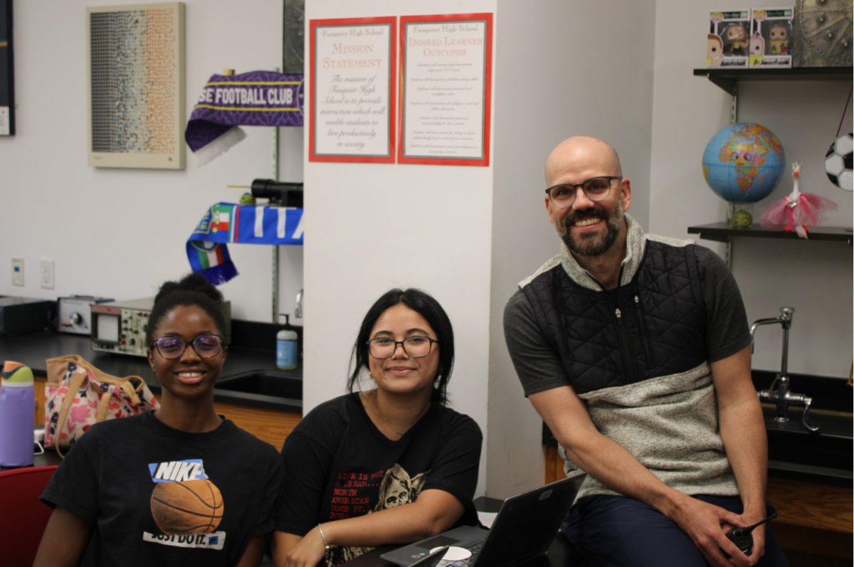 Principal Nick Brousse smiles with pride while working with FHS students.