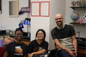Principal Nick Brousse smiles with pride while working with FHS students.