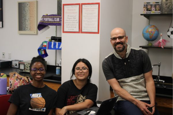 Principal Nick Brousse smiles with pride while working with FHS students.