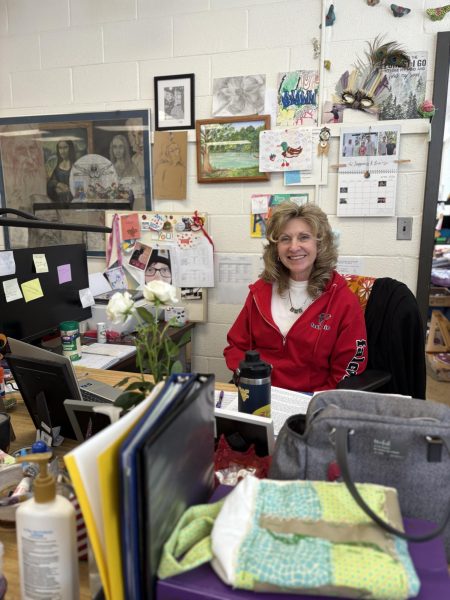 Seated with a smile, art teacher Dawn Brown reflects on a career filled with creativity.